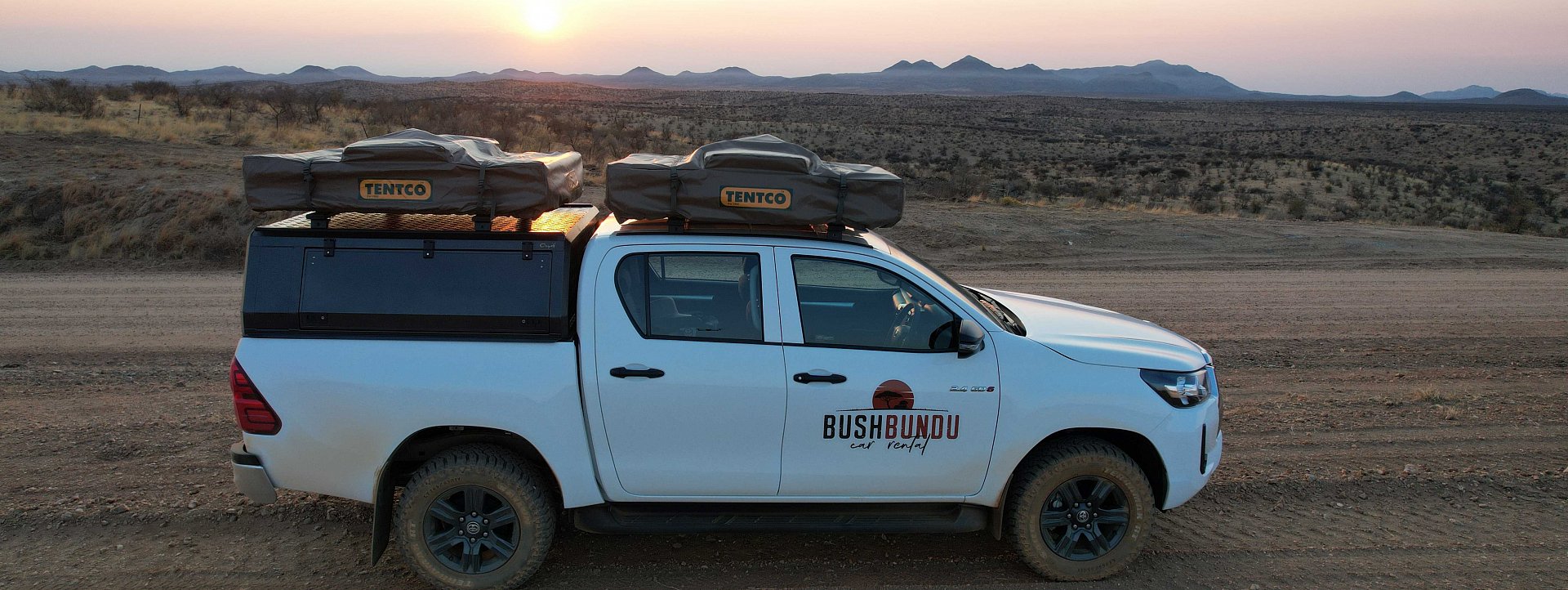 bushbundu-car-rental-windhoek-namibia-home-page-image-of-fully-equipped-with-camping-equipment-4x4-toyota-hilux-on-the-dessert-side-view
