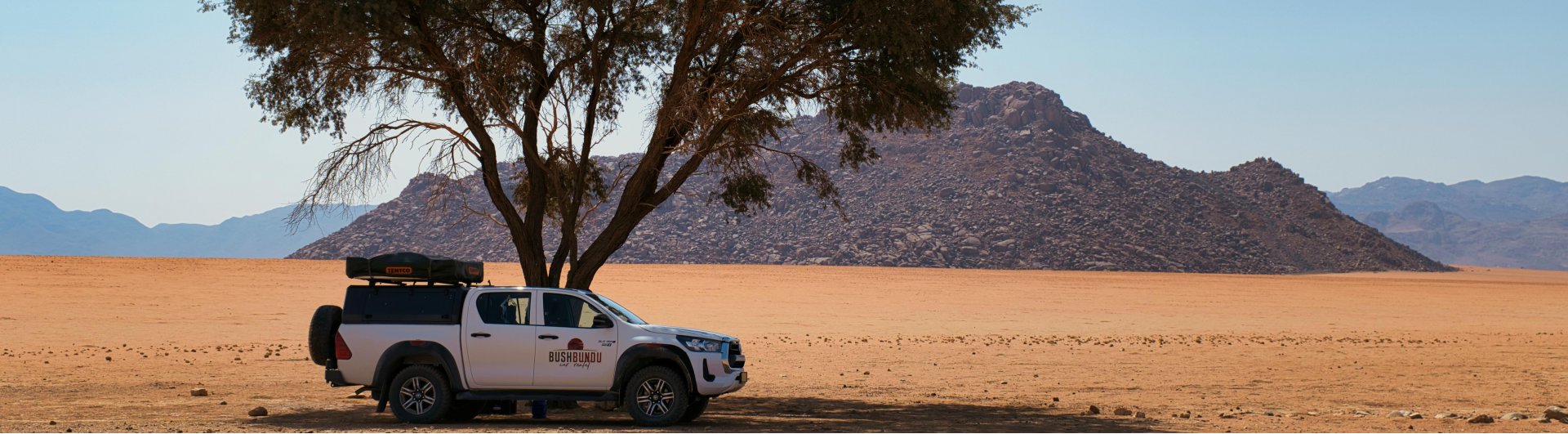 bushbundu-car-rental-windhoek-namibia-vehicle-rates-cover-image-namibia-desert-with-rock-formations