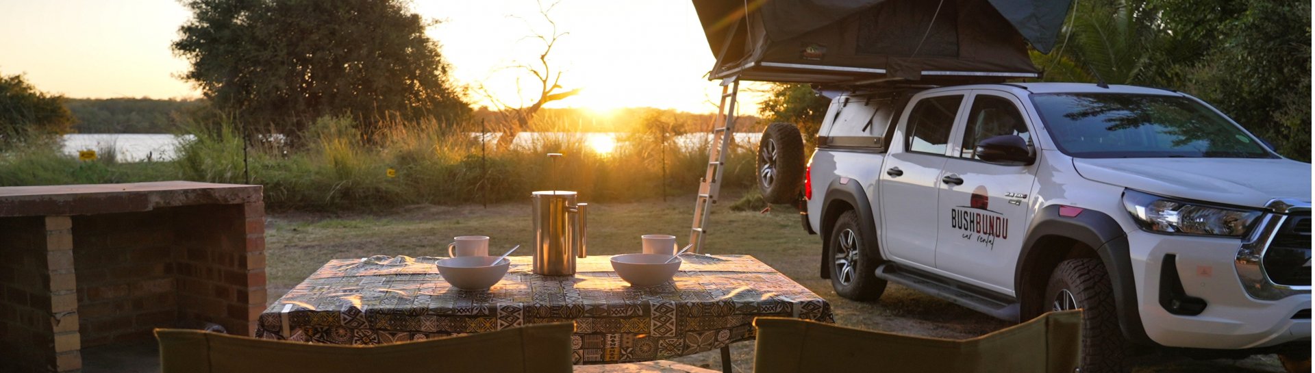 bushbundu-car-rental-windhoek-namibia-side-image-of-toyota-hilux-with-pitched-tent-on-the-roof-camping-page-cover-image
