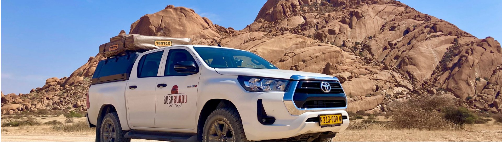bushbundu-car-rental-windhoek-namibia-vehicle-rates-cover-image-namibia-desert-with-rock-formations